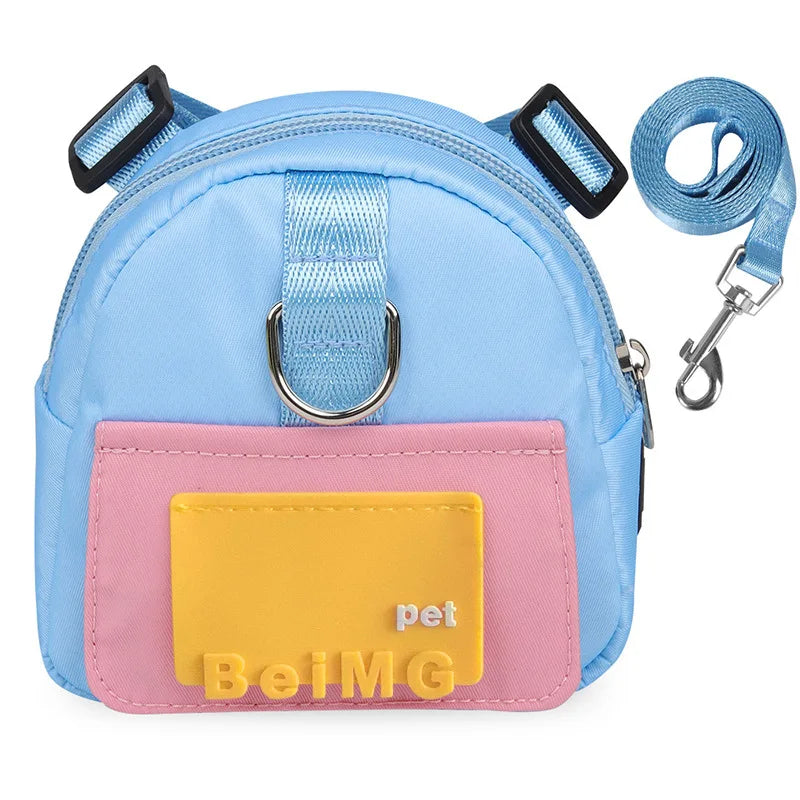 Light blue pet harness with pink patch and yellow label on a white background