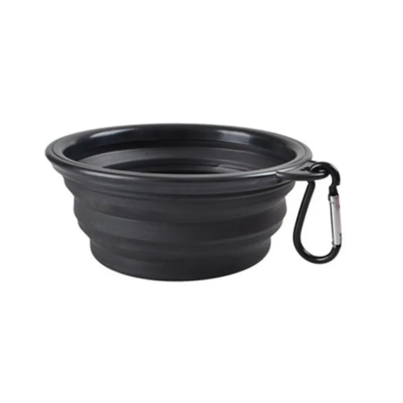 Black collapsible dog bowl with a carabiner on a white background