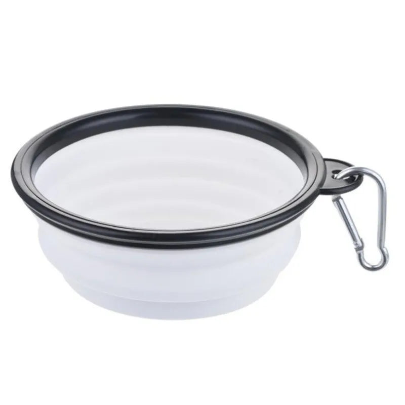 Collapsible white bowl with black rim and metal clip on a white background