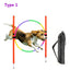 Dog jumping through a colorful hoop with training equipment on a white background