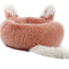 Fluffy pink pet bed with white accents 