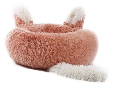 Fluffy pink pet bed with white accents 
