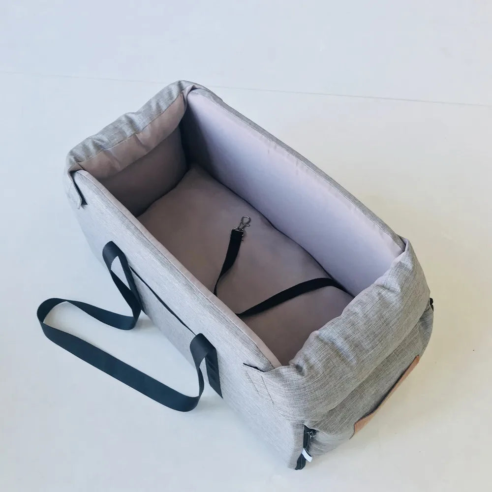 Gray pet carrier with a strap on a white background