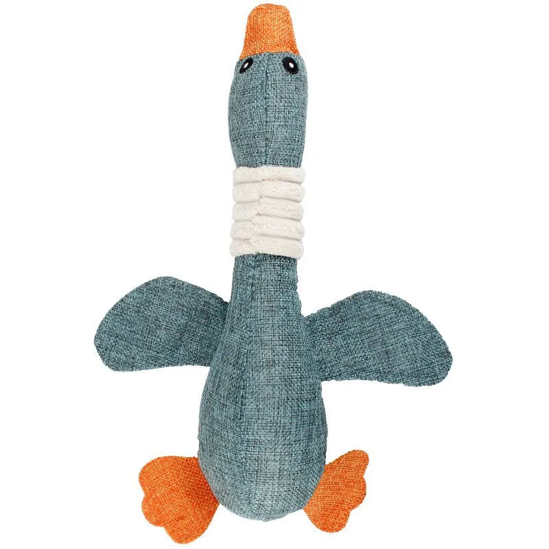 Knitted toy duck with orange beak and feet on a white background