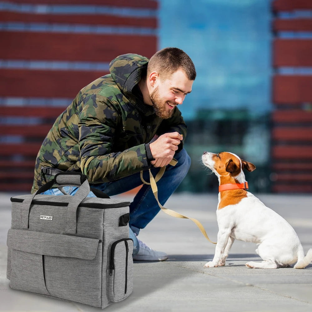 Man in camouflage jacket with a dog and a gray bag outdoors