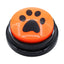 Orange button with a black paw print design on a white background
