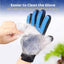 Pet grooming glove with blue bristles removing fur from a hand against a white background