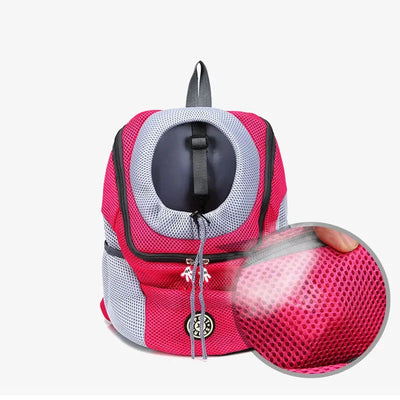 Pink and gray pet carrier with mesh side on a white background