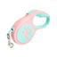 Pink and light blue retractable dog leash on a white background