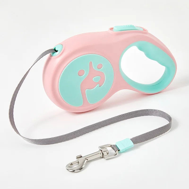 Pink and teal dog leash with a retractable design on a white background