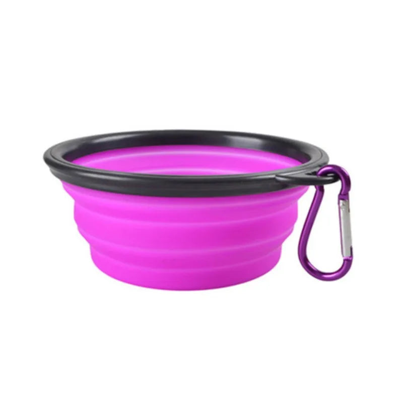 Purple silicone dog bowl with black rim and carabiner on a white background
