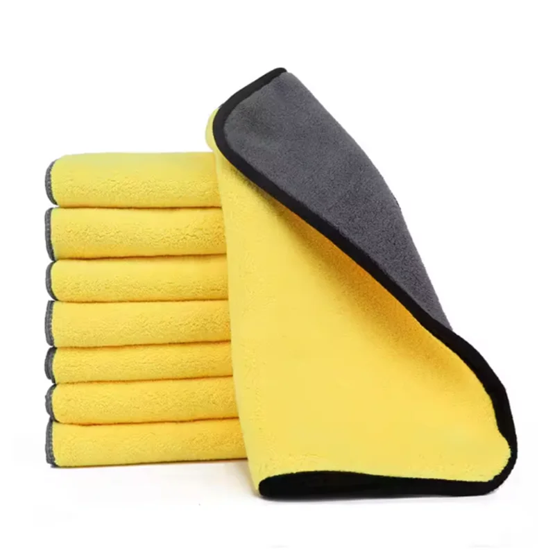 Set of yellow microfiber cloths with gray edges on a white background