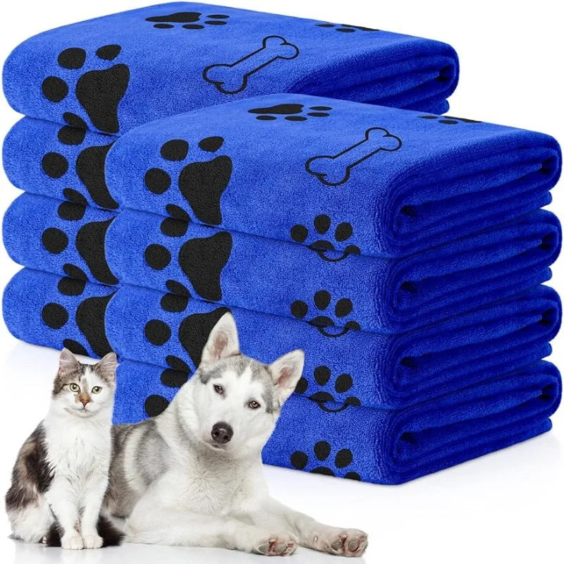 Stack of blue pet towels with paw and bone patterns, featuring a cat and dog in front.