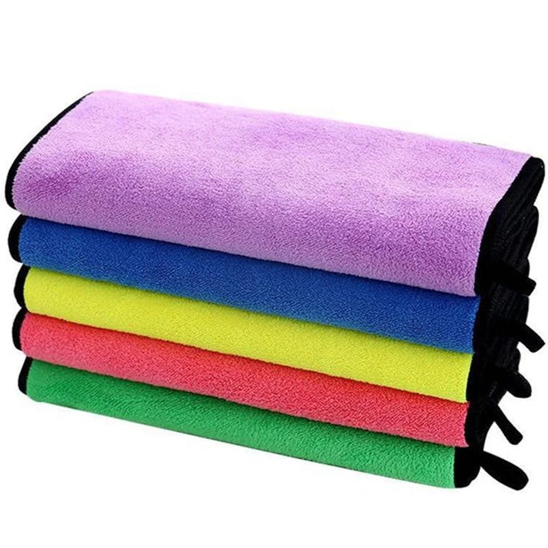 Stack of colorful microfiber cloths with black handles on a white background