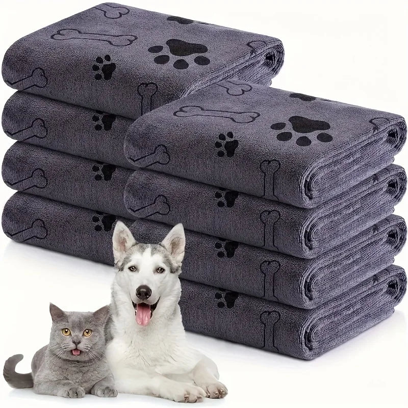 Stack of gray pet towels with paw and bone designs, featuring a dog and cat on a white background.
