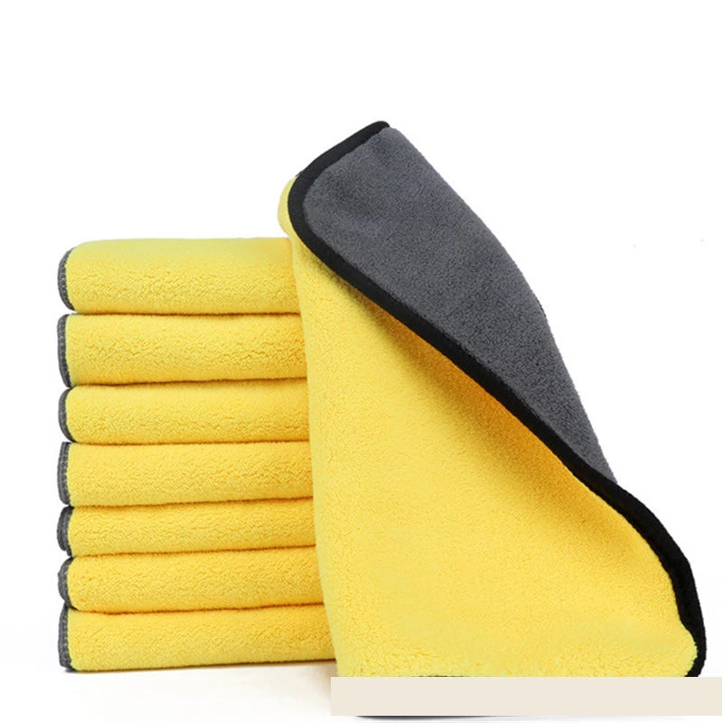 Stack of yellow microfiber cloths with a gray border on a white background