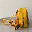 Yellow dog harness and leash set on a light gray background