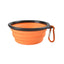 Orange collapsible dog bowl with black rim and carabiner on a white background