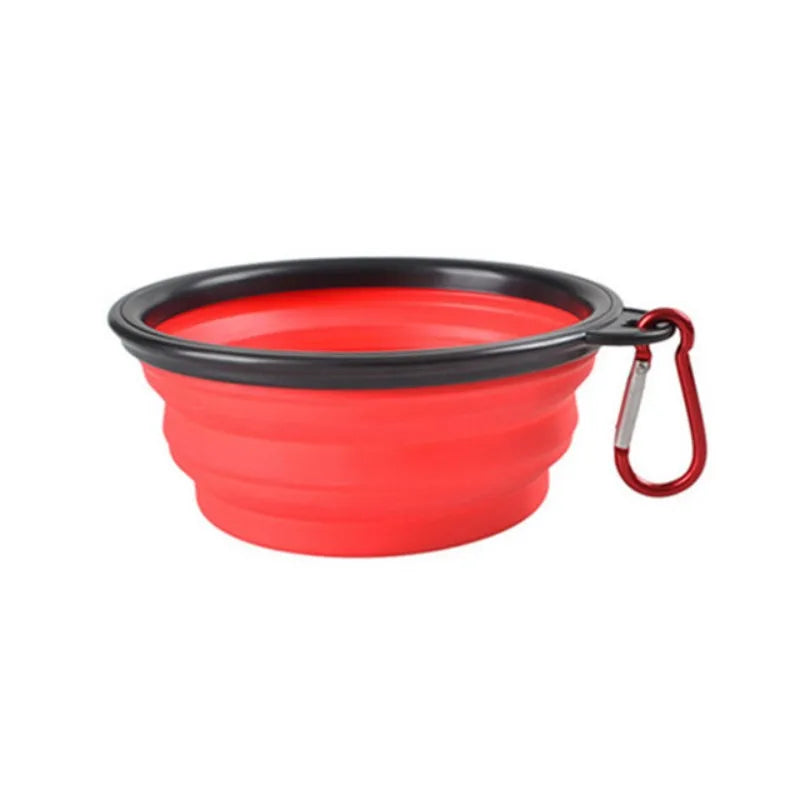 Red and black collapsible pet bowl with a carabiner on a white background